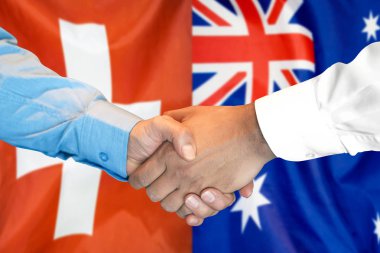 İsviçre ve Avustralya bayrak arka plan üzerinde el sıkışma.