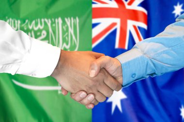 Suudi Arabistan ve Avustralya bayrak arka plan üzerinde el sıkışma.