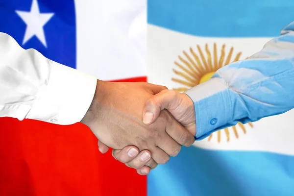 Handshake on Chile and Argentina flag background. — Stock Photo, Image