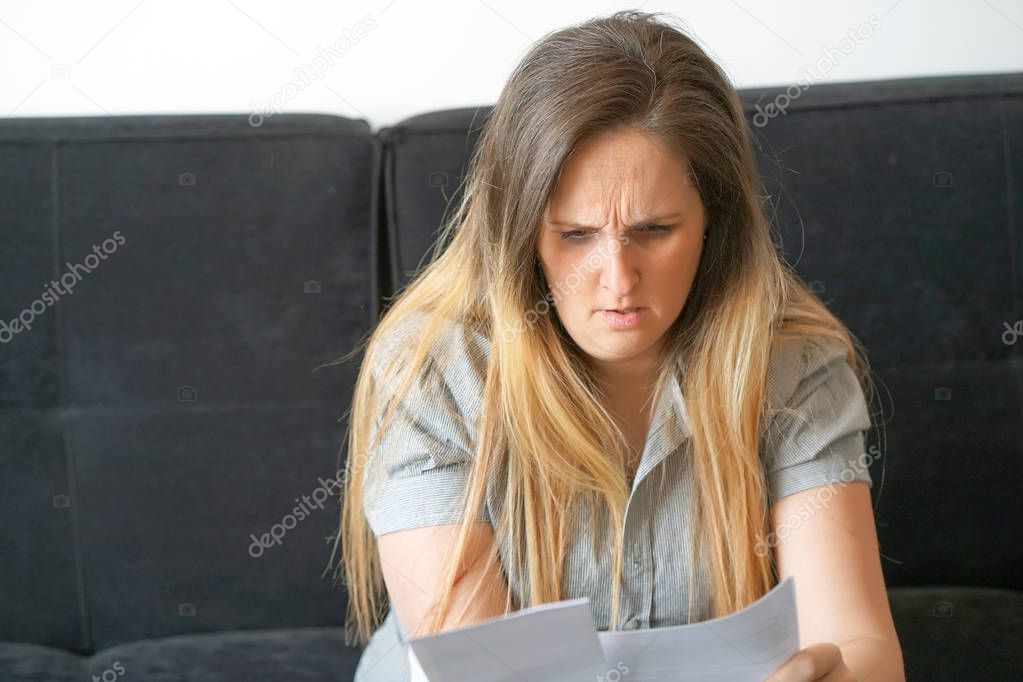 business woman reading a document in office workspace.