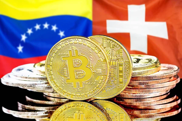 Bitcoins на фоне флага Венесуэлы и Швейцарии — стоковое фото