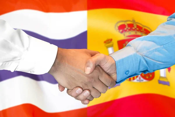 Handskakning om Thailand och Spanien flagga bakgrund. — Stockfoto