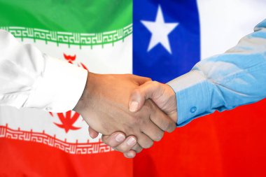 İran ve Şili bayrak arka plan üzerinde El sıkışma.