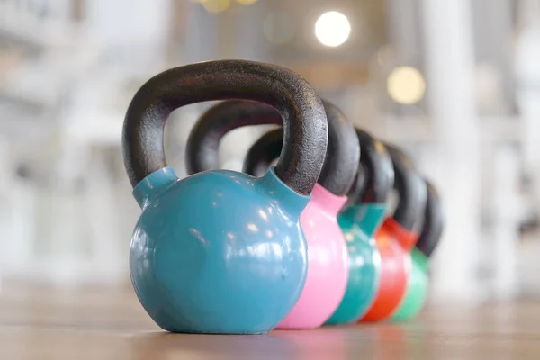 Colorful kettlebells in gym — Stock Photo, Image