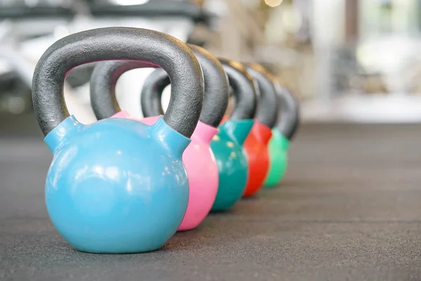 Colorful kettlebells in gym — Stock Photo, Image