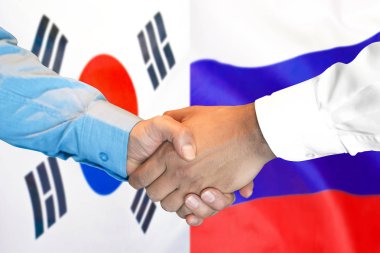 Güney Kore ve Rusya bayrak arka plan üzerinde El sıkışma.