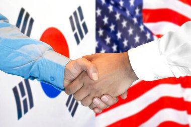 Güney Kore ve ABD bayrağı arka planda el sıkışma.