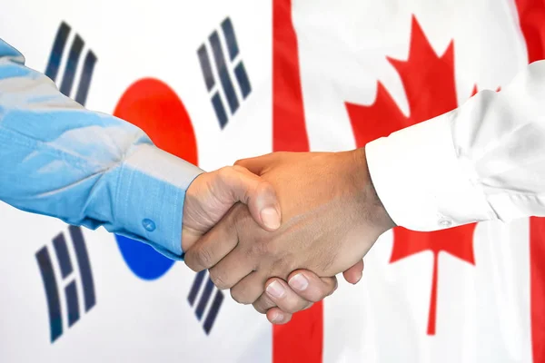 Apretón de manos en Corea del Sur y Canadá bandera de fondo . — Foto de Stock