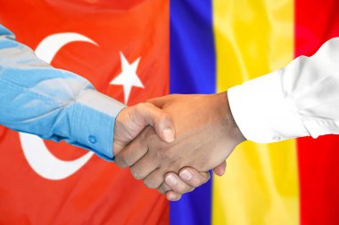 Türkiye ve Moldova bayrağı arka planında el sıkışma.