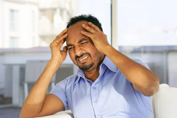 Sad african man lies on the bed. — Stock Photo, Image