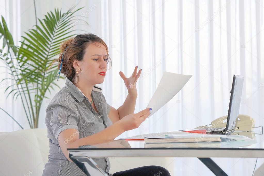 Business woman reading a document in office workspace