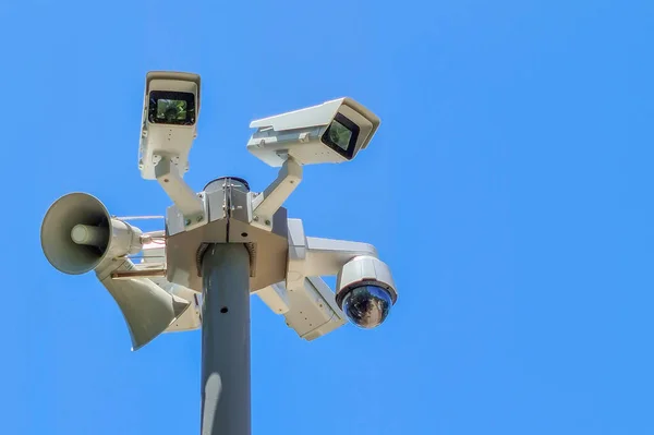 Security camera on blue sky background. Security camera and city video. CCTV Camera Technology. CCTV Camera Operating on street.