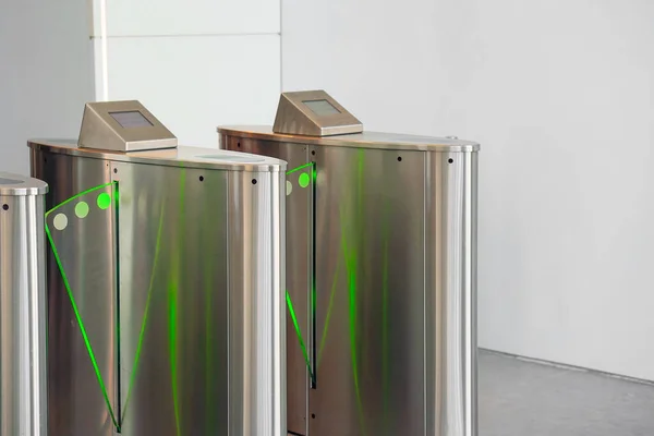 Automatic security turnstiles with card reader in a corporate office building. Automatic Security gateway and electronic card reader. Electronic card reader at office security gate.