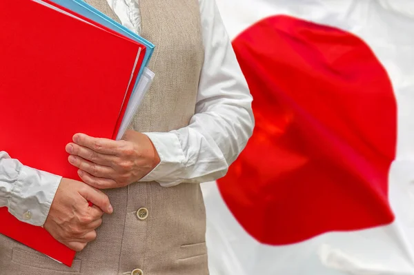 Woman holding red folder on Japan flag background. Education and jurisprudence concept in Japan