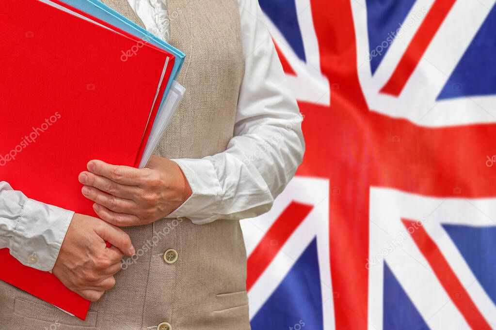 Woman holding red folder on United Kingdom flag background. Education and jurisprudence concept in UK