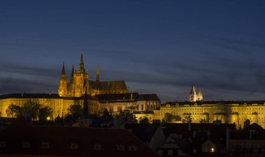 Night view of illuminated St. Vitus Cathedral gothic churche and Prague Castle panorama with hradcany, dark blue sky. clipart