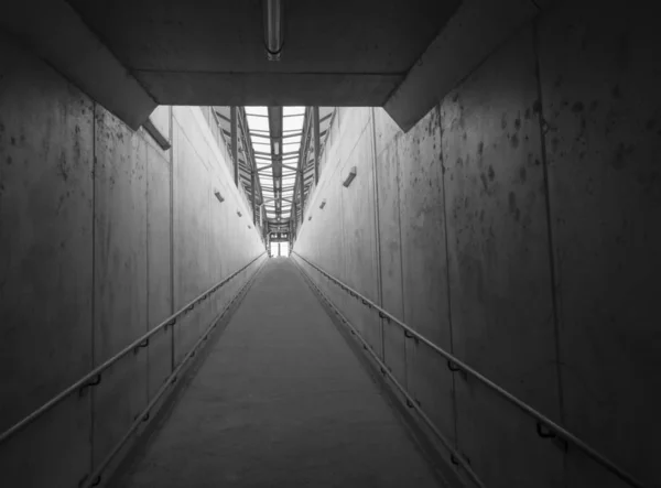 Empty concrete undergound passage platform subway on train station, balck and white, diminishing perspective