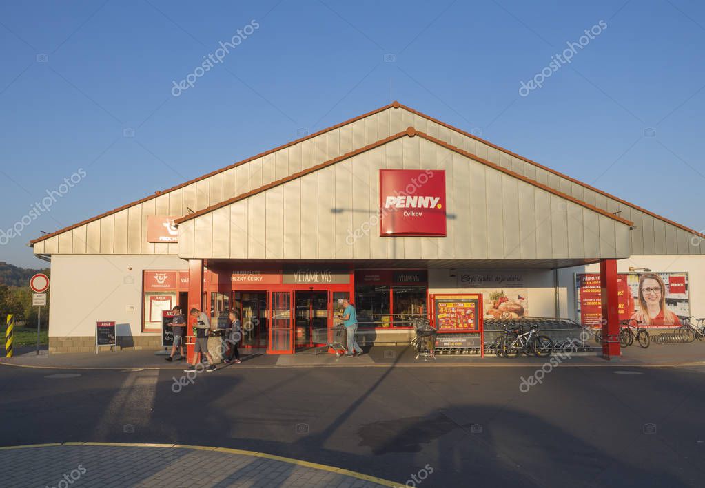 Czech republic, Cvikov, October 14, 2018: Entrance of Penny discount supermarket and shopping people, autumn sunny day, blue sky.