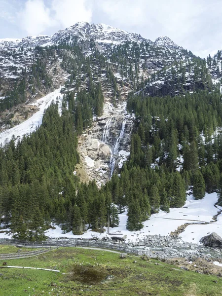 GRAWA Wasserfall Glacier Waterfall situated in Stubai Valley, Tyrol, Austria. Spring mountain river and trees landscape natural environment. Hiking in the alps.