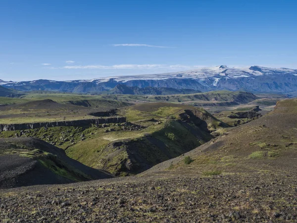 Исландский ландшафт с голубым каньоном реки Маркарфлиот, зелеными холмами и ледником вулкана Эяфьяллайокулл. Пешеходная тропа Лаугавегура. Заповедник Фьяллабак, Исландия. Голубое небо — стоковое фото