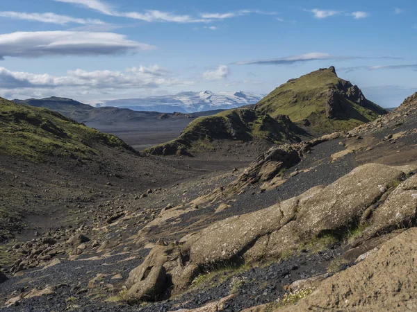 Islandzki krajobraz pustynny lawy z widokiem na góry lodowca Tindfjallajokull i zielone wzgórza. Rezerwat przyrody Fjallabak, Islandia. Lato błękitne niebo — Zdjęcie stockowe