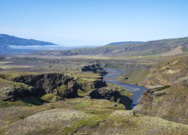 Icelandic landscape with blue Markarfljot river canyon, green hills and eyjafjallajokull volcano glacier. Laugavegur hiking trail. Fjallabak Nature Reserve, Iceland. Summer blue sky