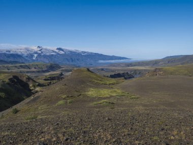 Icelandic landscape with blue Markarfljot river canyon, green hills and eyjafjallajokull volcano glacier. Laugavegur hiking trail. Fjallabak Nature Reserve, Iceland. Summer blue sky