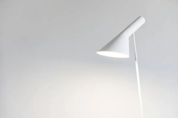 Modern floor lamp against white background. Home interior concept. The Scandinavian interior design is characterized by minimalism, simplicity, and functionality.