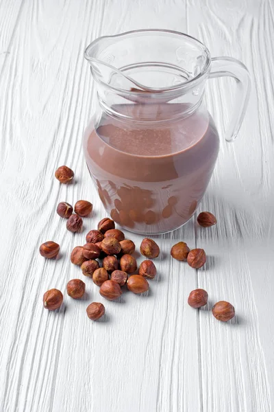 Healthy Natural Chocolate Milk Glass Jug Hazelnuts Breakfast White Wooden — Stock Photo, Image