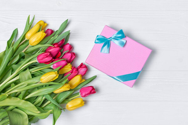Beautiful fresh yellow and pink tulips bouquet with gift box