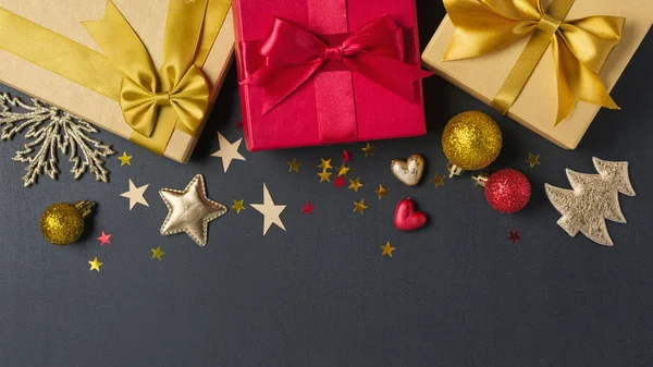 Zlaté a červené dárkové krabice s lesklým saténovým lukem a vánoční ozdobou — Stock fotografie