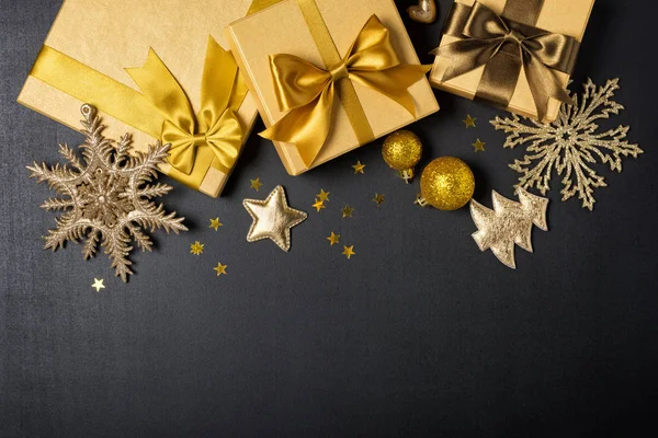 Cajas de regalo de oro con brillante arco de satén marrón y decoraciones de Navidad — Foto de Stock
