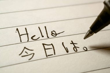 Beginner Japanese language learner writing Hello word in Japanes clipart