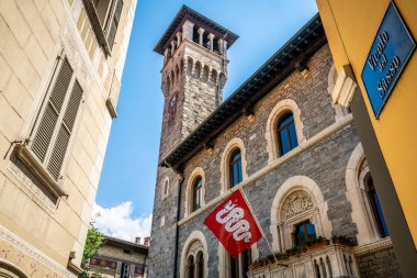 Exterior view of Bellinzona city hall and city flag with clock tower in Bellinzona Ticino Switzerland clipart