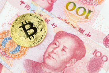 Altın bitcoin yüz Çin yuan banknotların arka plan yığını üzerinde. Cryptocurrency, dijital para yuan para faturaları ile.