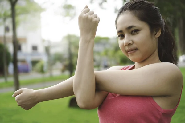 年轻健身妇女伸展手臂 Tricep 和肩部运动前后在公园室外 适合亚洲女性的运动衫做伸展在花园早晨 健康和生活方式概念 — 图库照片
