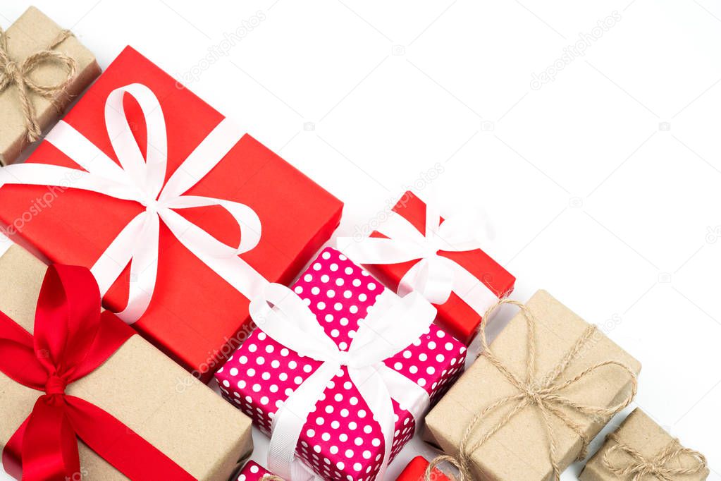 Set of Christmas red and brown gift boxes with white ribbon bow and brown robe bow on white background. New Year and happy birthday present decoration concept in flat layout and top view composition.