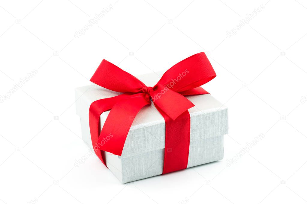 White gift box with red ribbon bow isolated on white background. Christmas, New Year and Birthday present.