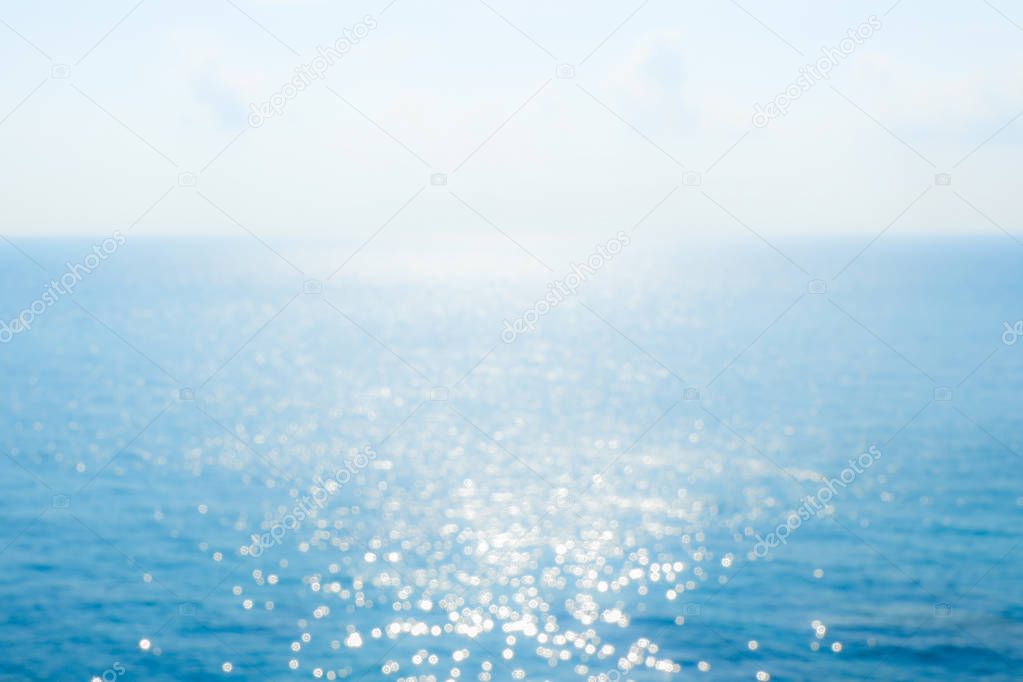 Abstract sunlight bokeh on blue sea background for summer season.