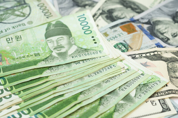 Korean won and US Dollar bills for money background in concepts of foreign money exchange, business and financial.