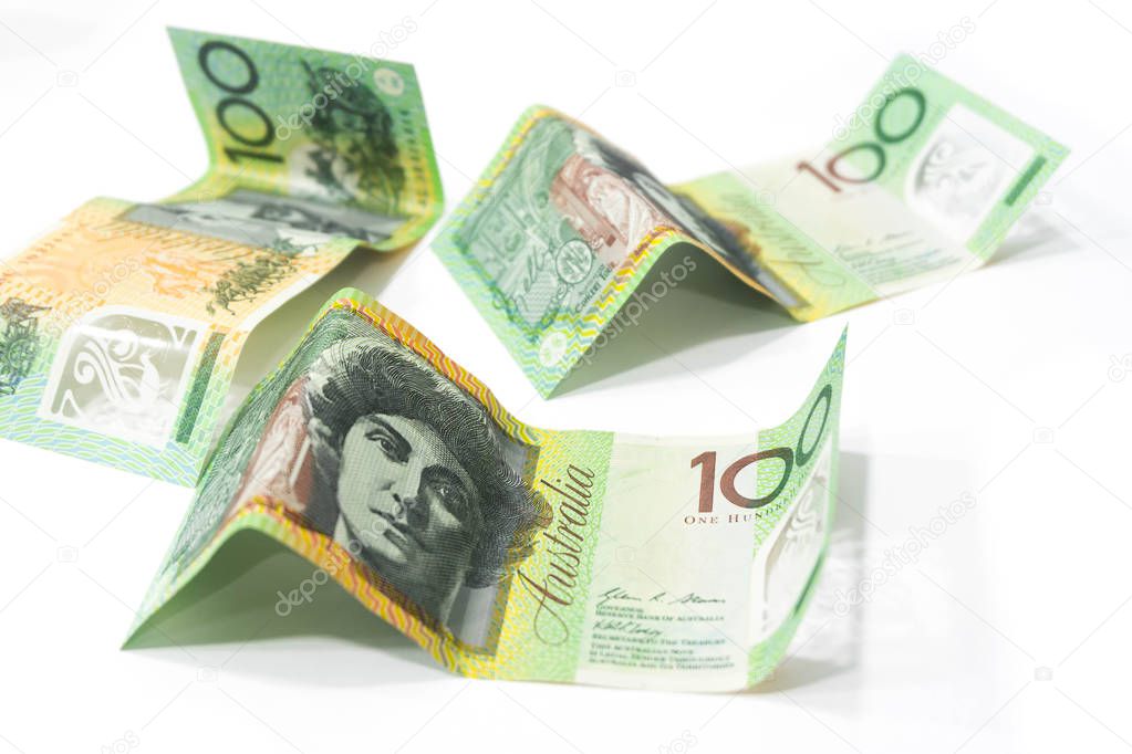 Pile of one hundred Australian dollar banknotes isolated on white background.