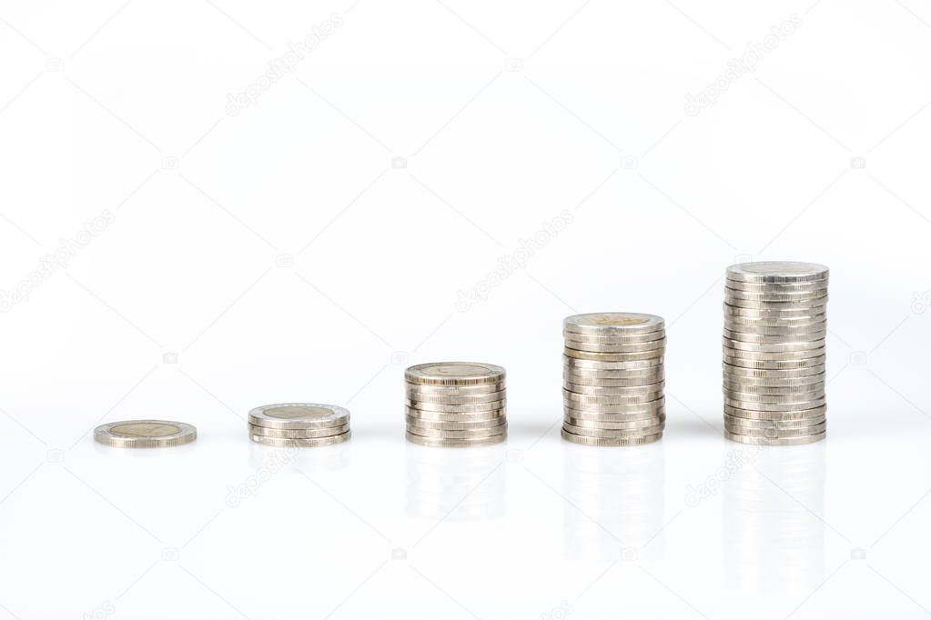 Savings, business growth, financial stability concept by several stacks of coins arrange as graph growing up on white background.
