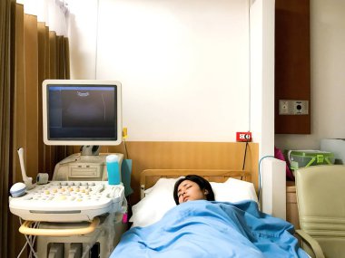 Young pregnant woman have painful from stomach ache and bleeding are lying on bed wait for meet doctor to checking symptoms by ultrasound and Per vaginal examination at hospital. clipart