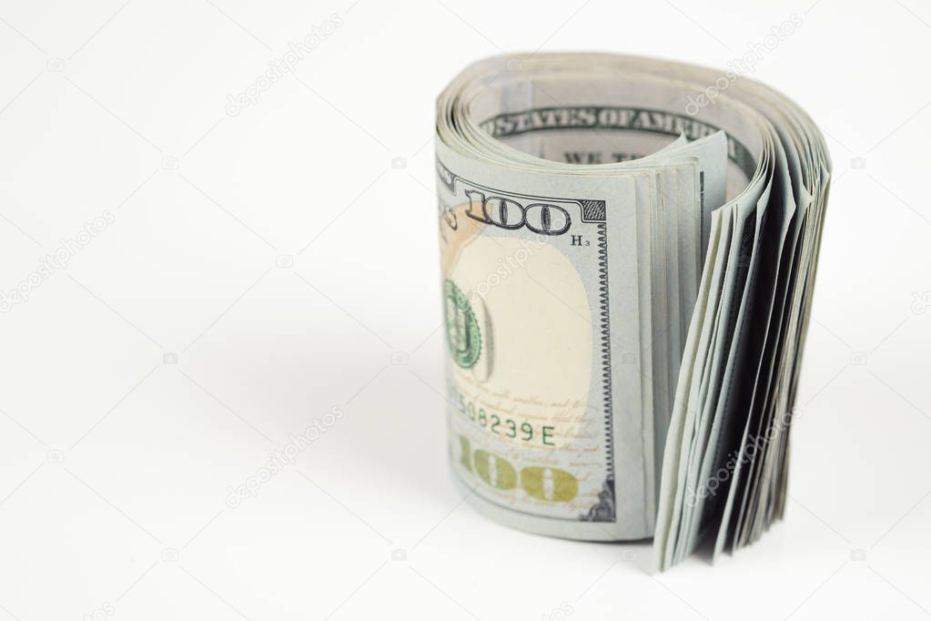 Close up the roll of one hundred dollar banknotes isolated on white background.