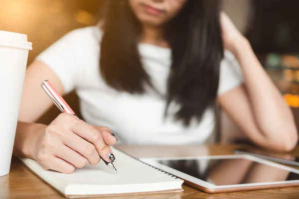 Asiatico Femmina Studente Scrittura Notebook Mentre Seduto Tavola Con Tablet — Foto Stock