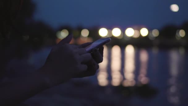 Attractive Asian Woman Using Mobile Phone Sitting River Night Street — Stock Video