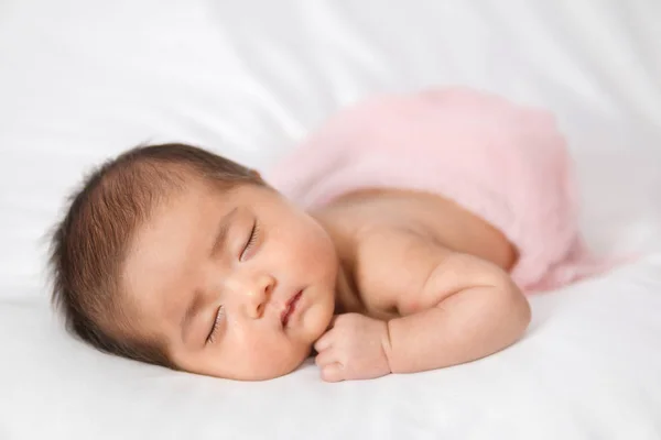 Adorable asian newborn baby in pink wrap sleeping on white blank — Stock Photo, Image