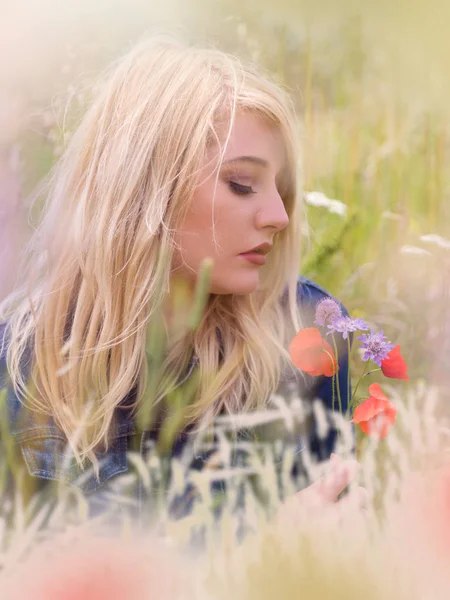 Jonge blonde vrouw met rode papaver bloemen — Stockfoto