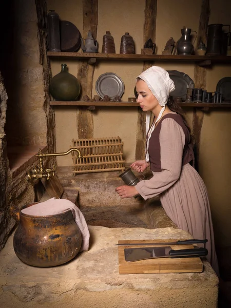 Vrouw in antieke keuken — Stockfoto