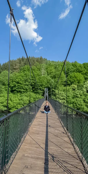 Photo session Freedom. Girl on the bridge. Pasarel Dam, a great place for walks, dreams, and photography in the fresh air amidst beautiful nature. Very close to the capital Sofia. Bulgaria.